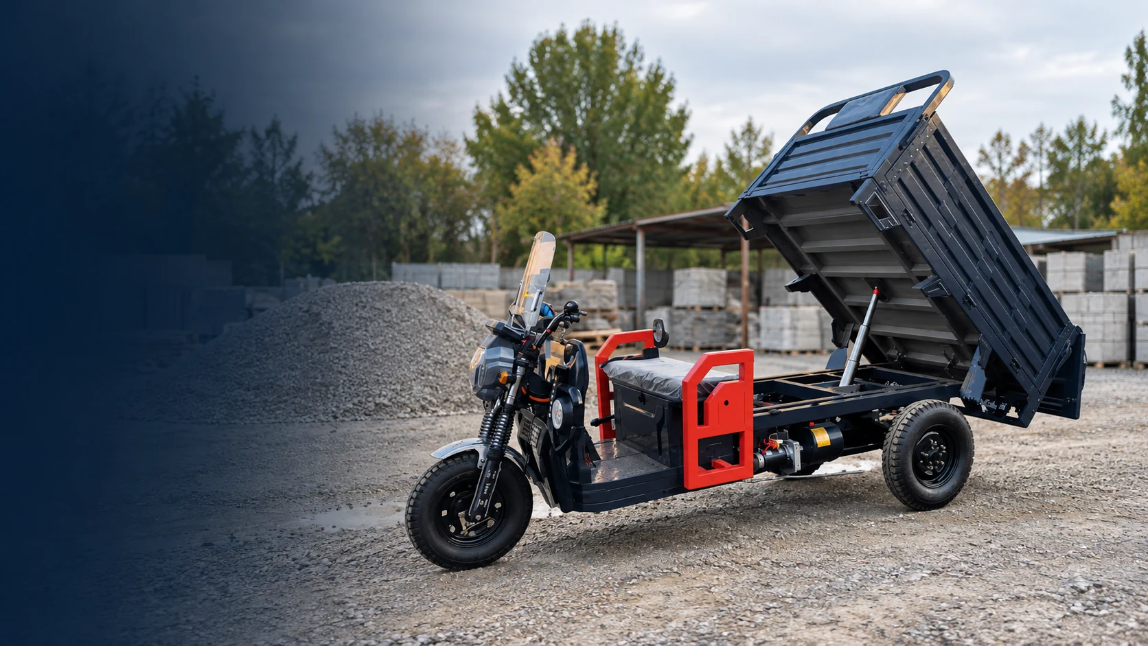 Electric cargo tricycle with raised dump bed at a worksite